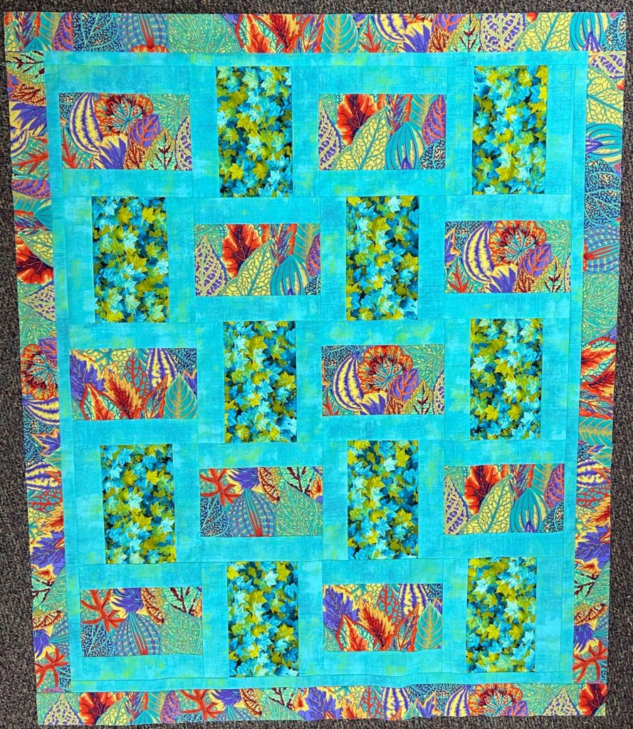 Teal and bright floral quilt top